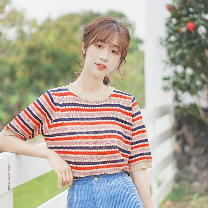レディースのストライプサマーニットを着た女性